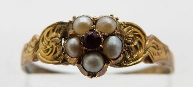 A Victorian ring set with red paste surrounded by seed pearls, size I, 0.