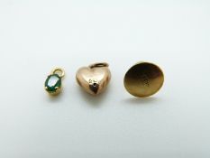 A 9ct gold heart charm set with a sapphire,