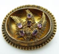A Victorian yellow metal mourning brooch with a textured fern design,
