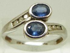 A 9ct white gold ring set with two oval cut sapphires and six diamonds, size P, 2.