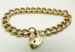A 9ct gold curb link bracelet with heart padlock clasp and engraved links, 42.