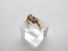 An 18ct gold ring set with two old cut diamonds, the largest approximately 0.35ct, size O, 5.