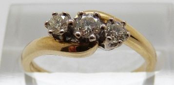 An 18ct gold ring set with three diamonds totalling approximately 0.33ct, size M, 3.