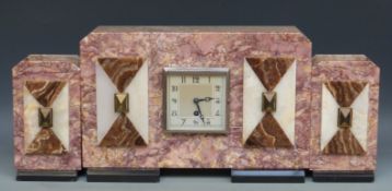 A pink marbled French clock garniture decorated with geometric contrasting panels in amber and