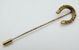 A Victorian stick pin set in the form of a horseshoe