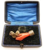 A Victorian brooch set with a hand holding a gilt rose