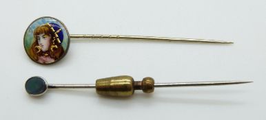 A white metal stick pin set with enamel depicting a young woman and an opal stick pin