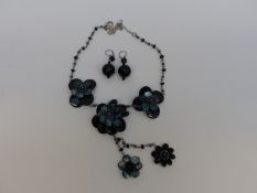 A Butler & Wilson necklace made up of three tiered flowers with earrings,