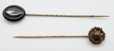 A Victorian stick pin set with a banded agate cabochon and a yellow metal Victorian stick pin