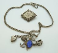 A silver Albert with silver charms and a Victorian silver brooch