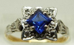 An 18ct gold ring set with a step cut sapphire and diamonds in a platinum setting, size M, 4.