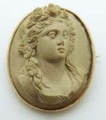 A 9ct gold brooch set with a lava cameo of a young woman
