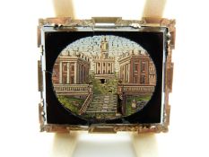 A Victorian yellow metal brooch set with a micro mosaic plaque depicting buildings,