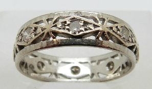 An 18ct white gold eternity ring set with diamonds with pierced decoration, size K, 3.