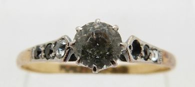 An 18ct gold ring set with a white sapphire, size O, 1.