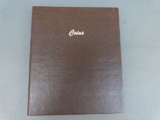 An amateur collection of coins in an album a good proportion being pre 1947 UK silver,