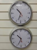 Two Alba quartz dial wall clocks with Arabic numerals and red seconds sweep