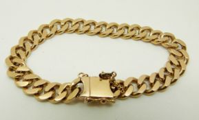 A yellow metal curb link bracelet marked 18k, 38.