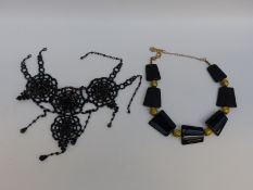 A Butler & Wilson necklace made up of alternating black and gold sections and another necklace,