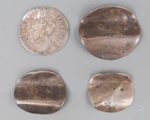 Four silver coins bent as love tokens, to include William III and George II examples,