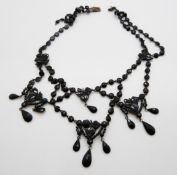 A French jet necklace of faceted pieces in a foliate design