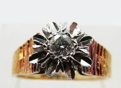 An 18ct gold ring with textured shoulders, set with a diamond of approximately 0.