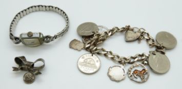 Silver charm bracelet and a silver bow brooch