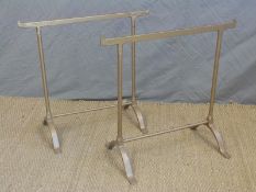 A pair of cast iron trestles, could be used as towel rails,