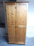 A pine two door wardrobe,