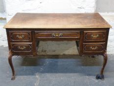 French style oak twin pedestal desk raised on cabriole legs,