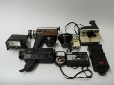 A quantity of cameras and accessories including Polaroid, Topcor 80m 1:4 lens,