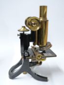 Swift late 19th / early 20thC cased microscope with Travis mechanical stage and extra eyepieces