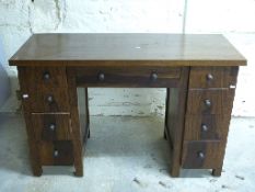 Oak or similar kneehole desk with four drawers to each side and a single central drawer,