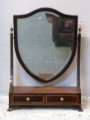 A 19thC inlaid mahogany bevelled glass shield shaped dressing table mirror,