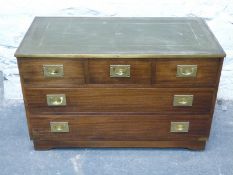 A campaign style chest of three over two drawers,