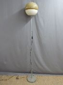A retro style standard lamp with globular plastic shade,