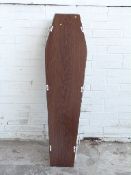 An adult sized coffin in oak finish with chromed fittings,
