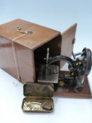 Cased Willcox & Gibbs sewing machine and accessories