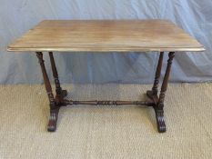 A 19thC mahogany sofa table raised on four turned supports united by a tapered stretcher,