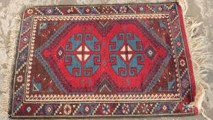 Small Turkish wool rug with blue guls to a red ground,