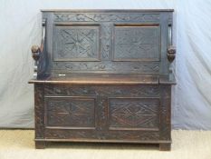 A carved oak monks bench,