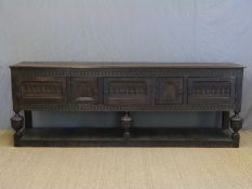 An 18th / 19thC large carved oak sideboard or dresser base in the Tudor style,