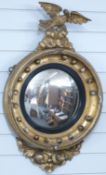 Regency giltwood framed mirror with convex glass and eagle to top,