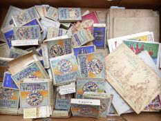 A box of cigarette card albums, John Player, WD & HO Wills etc, comic postcards together with a V.P.
