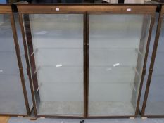 Ex Victoria & Albert Museum early 20thC two door glass display cabinet with bronzed frame,