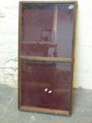 A glazed pine display case with velvet lining,