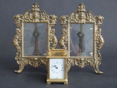 A pair of brass photograph frames and a brass cased carriage clock