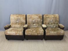 Three retro armchairs, the arms of which can be removed in order to form a sofa,