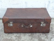 Large leather suitcase or trunk with corner protectors and lined interior,