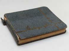 An autograph album with signatures including Stan Laurel and Oliver Hardy, Arthur English,